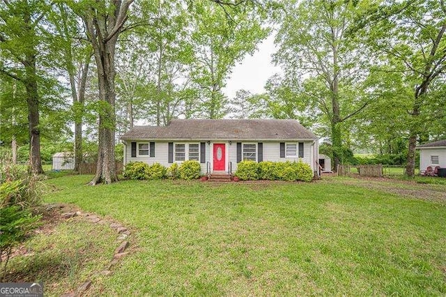 ranch-style house with fence, a front yard, and entry steps