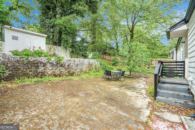 248 Upshaw St SW, Atlanta, GA 30315 - fenced backyard featuring a patio, outdoor dining space, and an outdoor structure