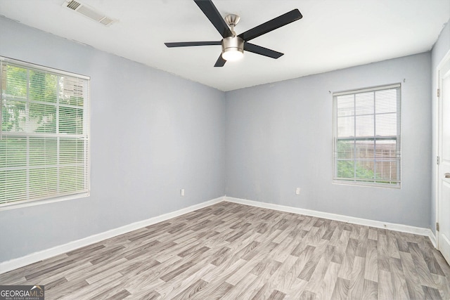 248 Upshaw St SW, Atlanta, GA 30315 - empty room with light wood-style floors, healthy amount of natural light, and a ceiling fan