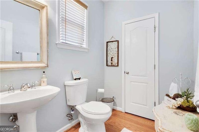 233 Hampton Station Blvd, Canton, GA 30115 - half bathroom featuring baseboards, toilet, and wood finished floors