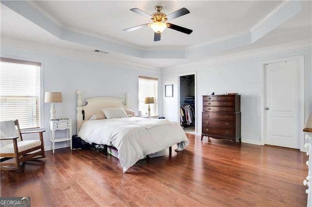 233 Hampton Station Blvd, Canton, GA 30115 - bedroom with visible vents, wood finished floors, a tray ceiling, and multiple windows