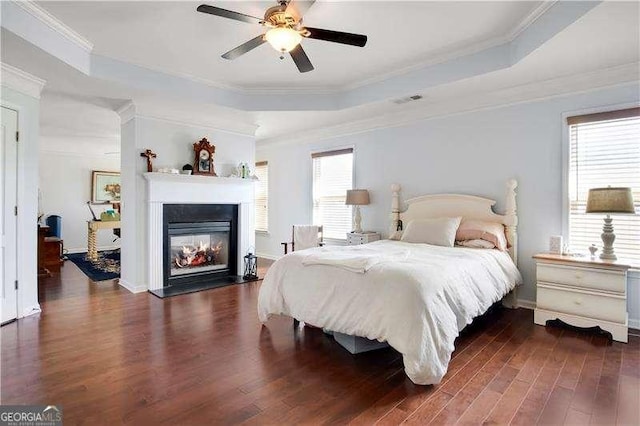 233 Hampton Station Blvd, Canton, GA 30115 - bedroom featuring a multi sided fireplace, visible vents, wood finished floors, a raised ceiling, and ornamental molding