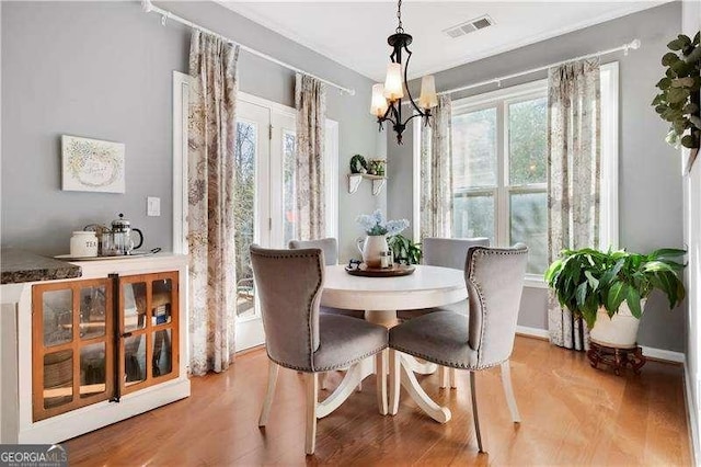 233 Hampton Station Blvd, Canton, GA 30115 - dining space with visible vents, wood finished floors, and an inviting chandelier