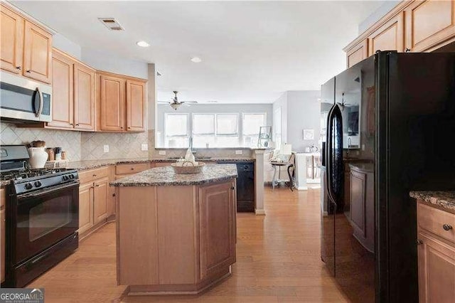 233 Hampton Station Blvd, Canton, GA 30115 - kitchen featuring ceiling fan, light wood-style flooring, a peninsula, a kitchen island, and black appliances