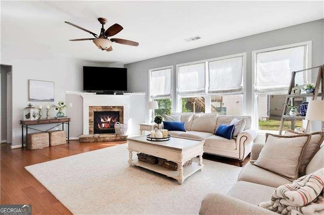 233 Hampton Station Blvd, Canton, GA 30115 - living room featuring visible vents, wood finished floors, baseboards, a stone fireplace, and ceiling fan
