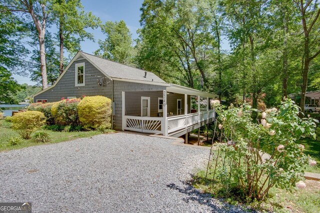 view of side of home featuring covered porch
