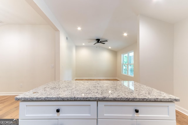 kitchen with white cabinetry, ceiling fan, light wood-style floors, and vaulted ceiling