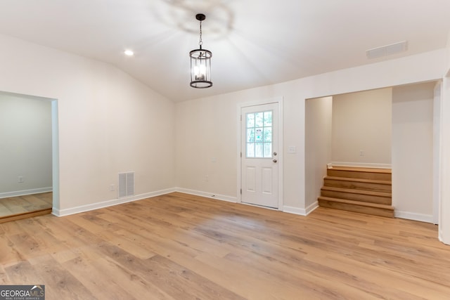 entrance foyer with visible vents, stairs, and light wood finished floors