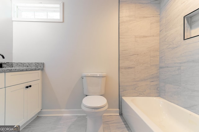 bathroom with a washtub, baseboards, toilet, vanity, and marble finish floor