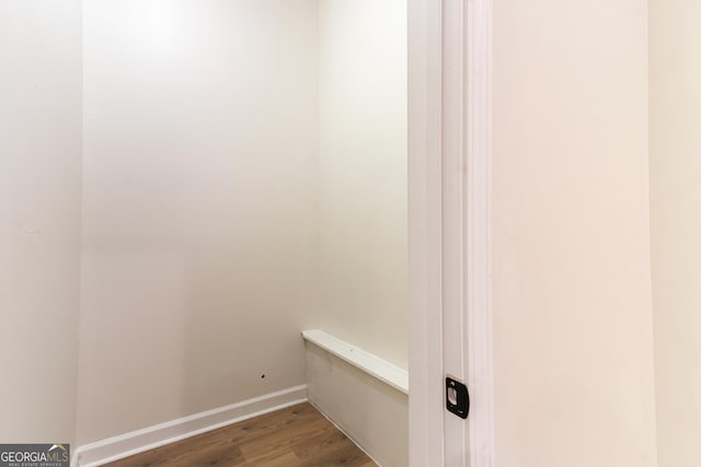 interior details featuring wood finished floors and baseboards