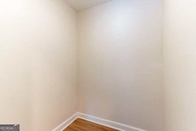 empty room with light wood-style floors and baseboards