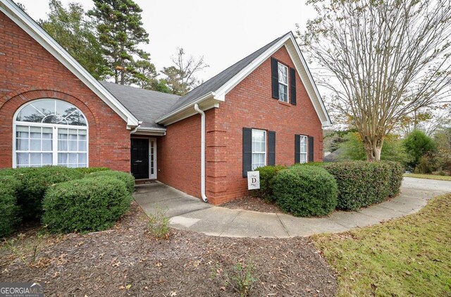 95 Blue Grass Ct, Oxford, GA 30054 - view of front facade featuring roof with shingles and brick siding
