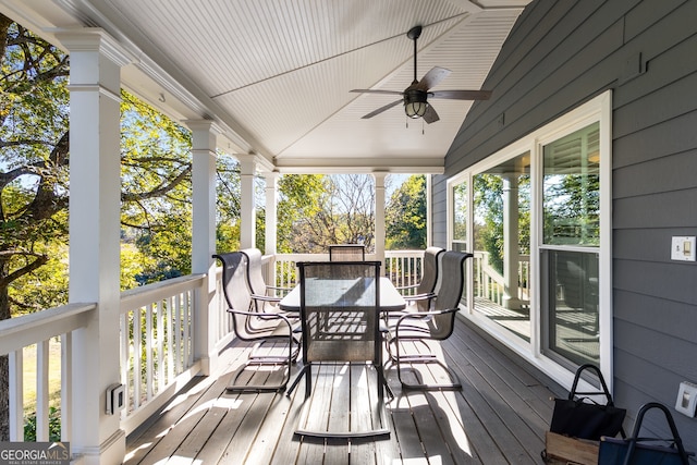 sunroom featuring a ceiling fan, outdoor dining space, and a wealth of natural light