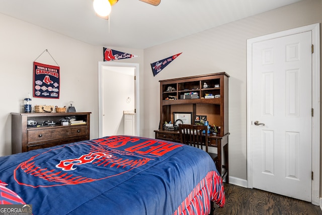 bedroom featuring dark wood-style flooring, a ceiling fan, and baseboards