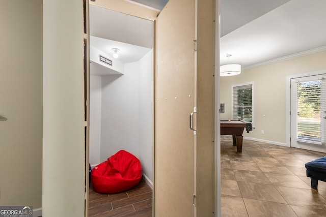 interior space featuring ornamental molding and baseboards