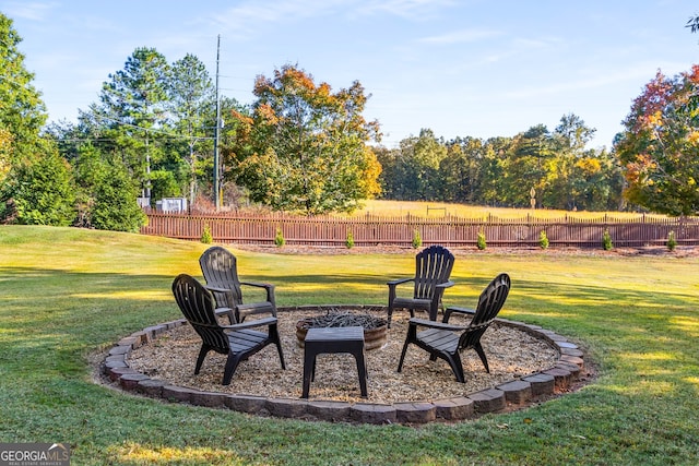 view of yard with a fire pit and fence