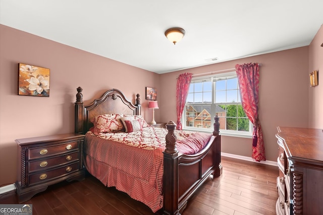 bedroom with baseboards, visible vents, and dark wood-style floors