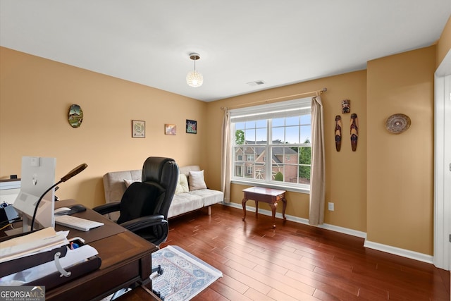 home office featuring baseboards, visible vents, and wood finished floors