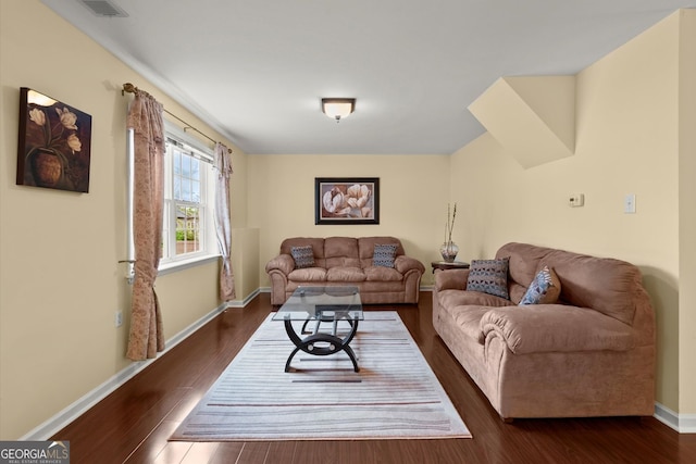 living room featuring baseboards, wood finished floors, and visible vents