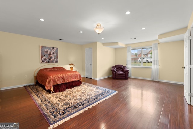 bedroom featuring baseboards, recessed lighting, and wood finished floors