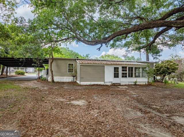 168 Chapman St Unit 1And16, Norman Park, GA 31771 - exterior space featuring driveway, metal roof, a detached carport, and a sunroom