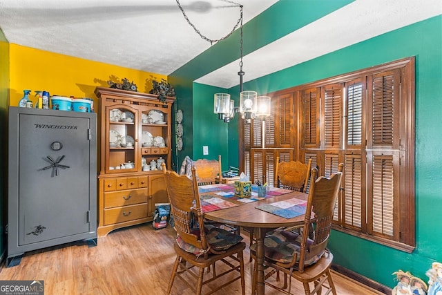 dining space with a chandelier and wood finished floors
