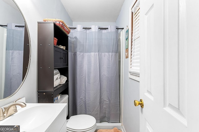 bathroom featuring toilet, curtained shower, vanity, and baseboards