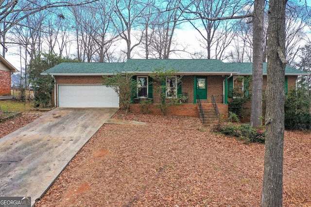 single story home with brick siding, roof with shingles, driveway, and an attached garage