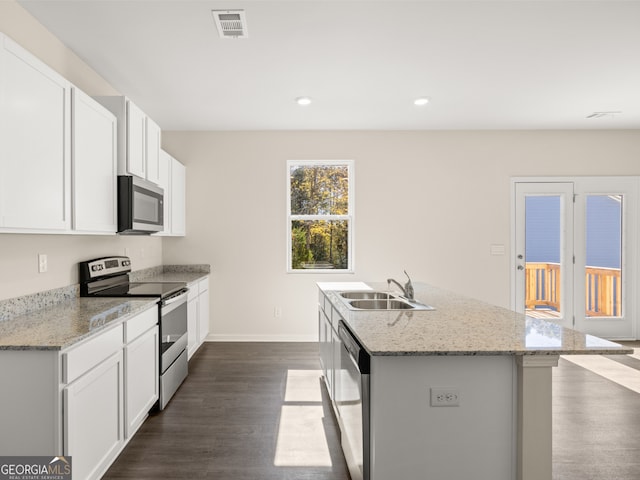 8230 Coldstream Dr, Fairburn, GA 30213 - kitchen with appliances with stainless steel finishes, dark wood-style floors, a center island with sink, white cabinets, and recessed lighting