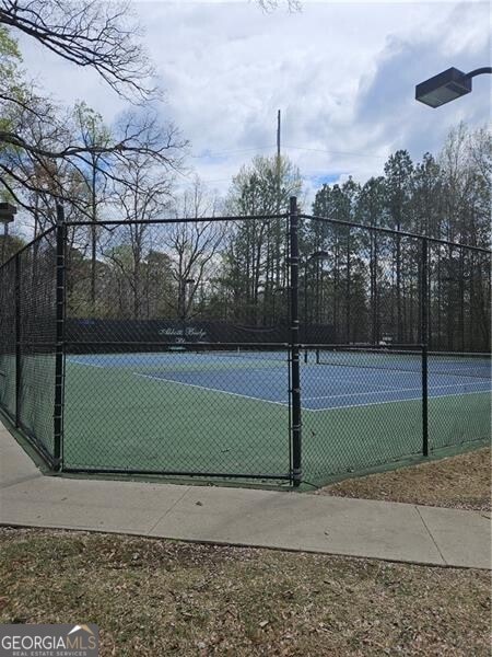 view of sport court featuring fence