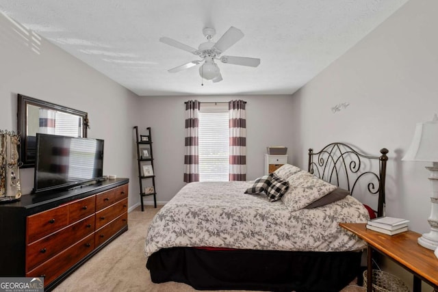 bedroom featuring a ceiling fan and light carpet
