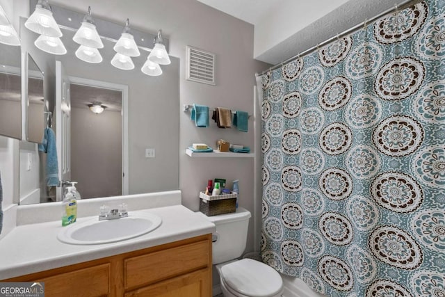bathroom with visible vents, toilet, curtained shower, and vanity