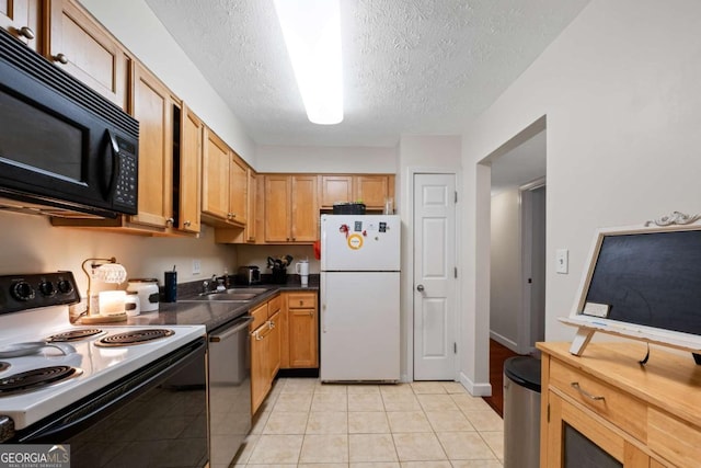 kitchen with stainless steel dishwasher, a sink, black microwave, freestanding refrigerator, and electric range