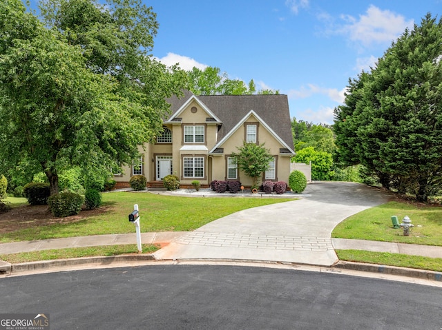 209 Braemar Ct, Mcdonough, GA 30253 - view of front facade featuring a front lawn, stucco siding, and driveway