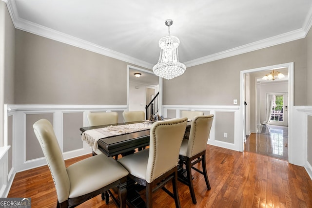 209 Braemar Ct, Mcdonough, GA 30253 - dining space featuring ornamental molding, a chandelier, and hardwood / wood-style floors