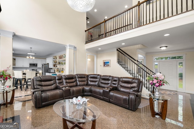 209 Braemar Ct, Mcdonough, GA 30253 - living room with an inviting chandelier, ornamental molding, stairs, and a towering ceiling