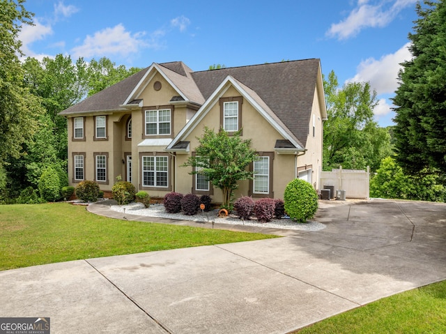 209 Braemar Ct, Mcdonough, GA 30253 - view of front of property featuring fence, roof with shingles, stucco siding, a front yard, and driveway