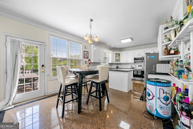 209 Braemar Ct, Mcdonough, GA 30253 - dining room with baseboards, ornamental molding, granite finish floor, and a chandelier