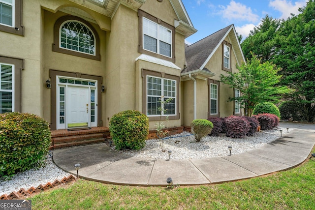 209 Braemar Ct, Mcdonough, GA 30253 - view of exterior entry featuring a shingled roof and stucco siding