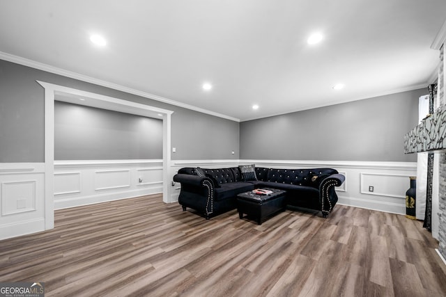 209 Braemar Ct, Mcdonough, GA 30253 - living room featuring ornamental molding, wood finished floors, and a wainscoted wall