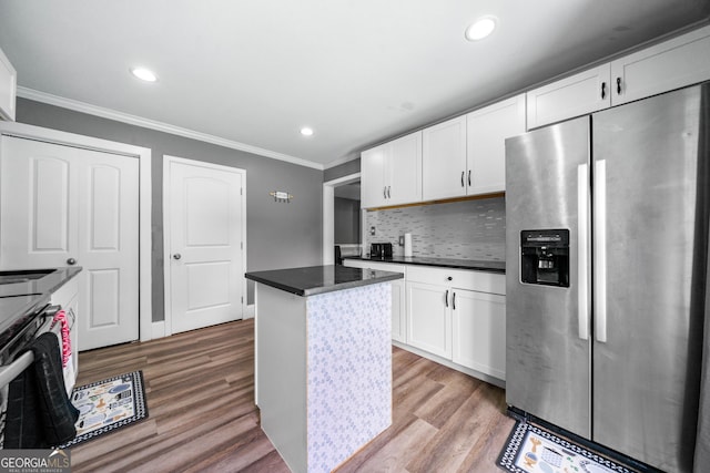 209 Braemar Ct, Mcdonough, GA 30253 - kitchen with backsplash, white cabinets, light wood finished floors, stainless steel fridge, and ornamental molding