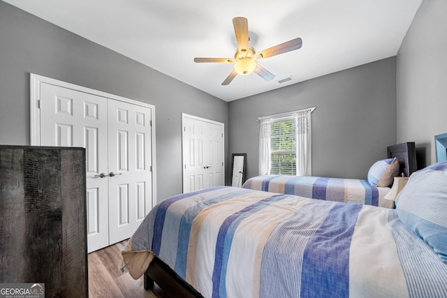 209 Braemar Ct, Mcdonough, GA 30253 - bedroom featuring ceiling fan, multiple closets, wood finished floors, and visible vents