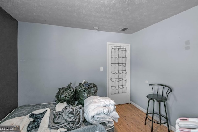 3162 Citrus Ct, Decatur, GA 30034 - bedroom featuring a textured ceiling, visible vents, wood finished floors, and baseboards