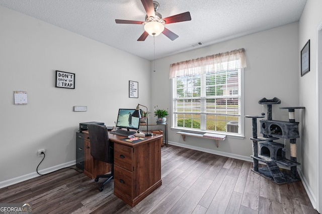 home office featuring a textured ceiling, wood finished floors, a ceiling fan, and visible vents