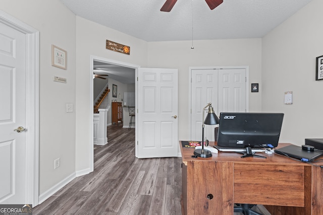 office space with baseboards, wood finished floors, a ceiling fan, and a textured ceiling