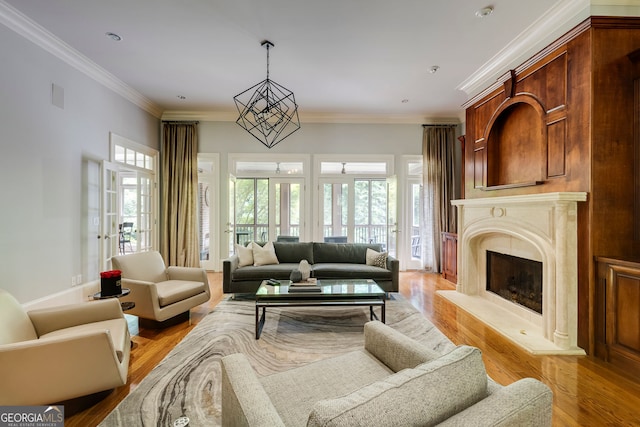 living area featuring light wood-style flooring, ornamental molding, and a premium fireplace