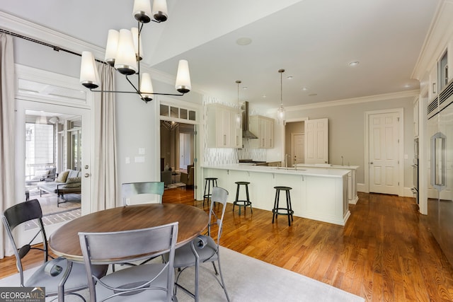 dining area with ornamental molding, dark wood-style flooring, and recessed lighting