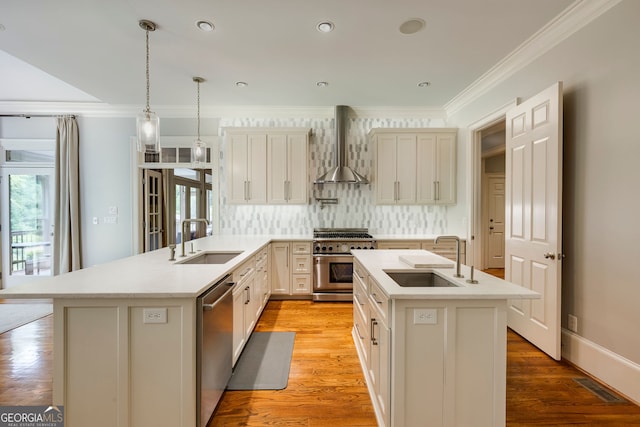 kitchen featuring stainless steel appliances, wall chimney exhaust hood, a sink, tasteful backsplash, and ornamental molding
