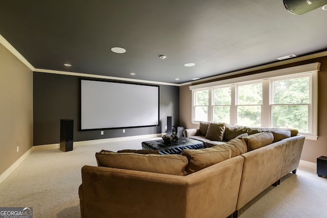home theater with ornamental molding, light colored carpet, baseboards, and recessed lighting