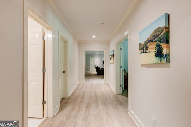 hall with crown molding, light wood-style flooring, baseboards, and recessed lighting